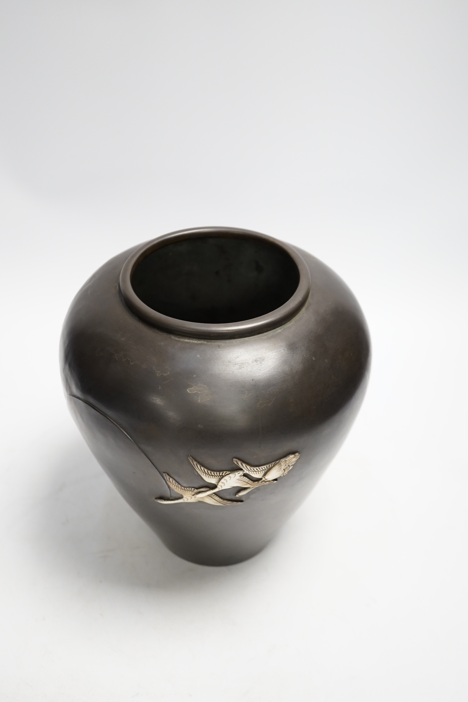 A Japanese white metal overlaid bronze vase, Meiji period, 21cm